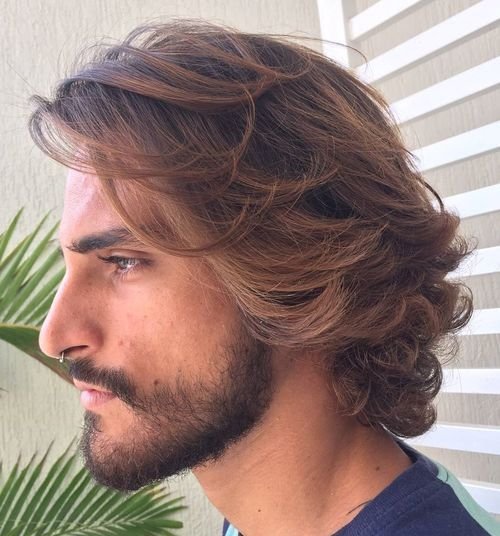 Medium-length layered hair with a loose side sweep and natural movement