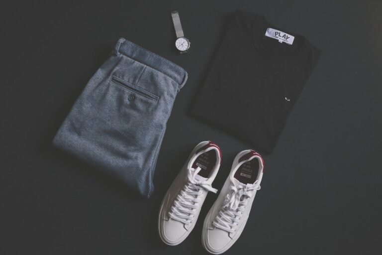 Flat lay of a dark T-shirt, jeans, shoes and accessories