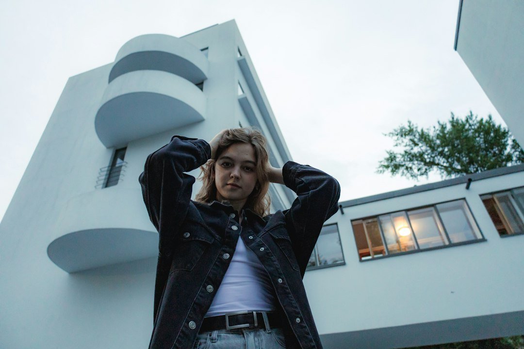 Dark jacket over a white tee with pale jeans
