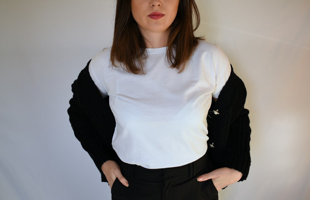 Plain white T-shirt framed by dark outer clothing