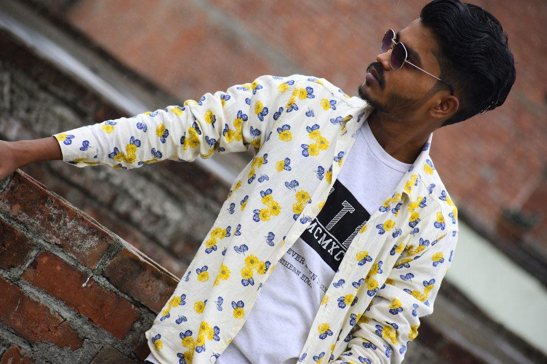 Printed shirt worn open over a white graphic T-shirt