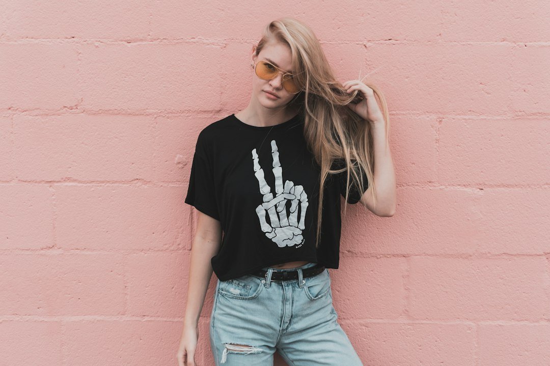 Black graphic tee with a visible denim waistband