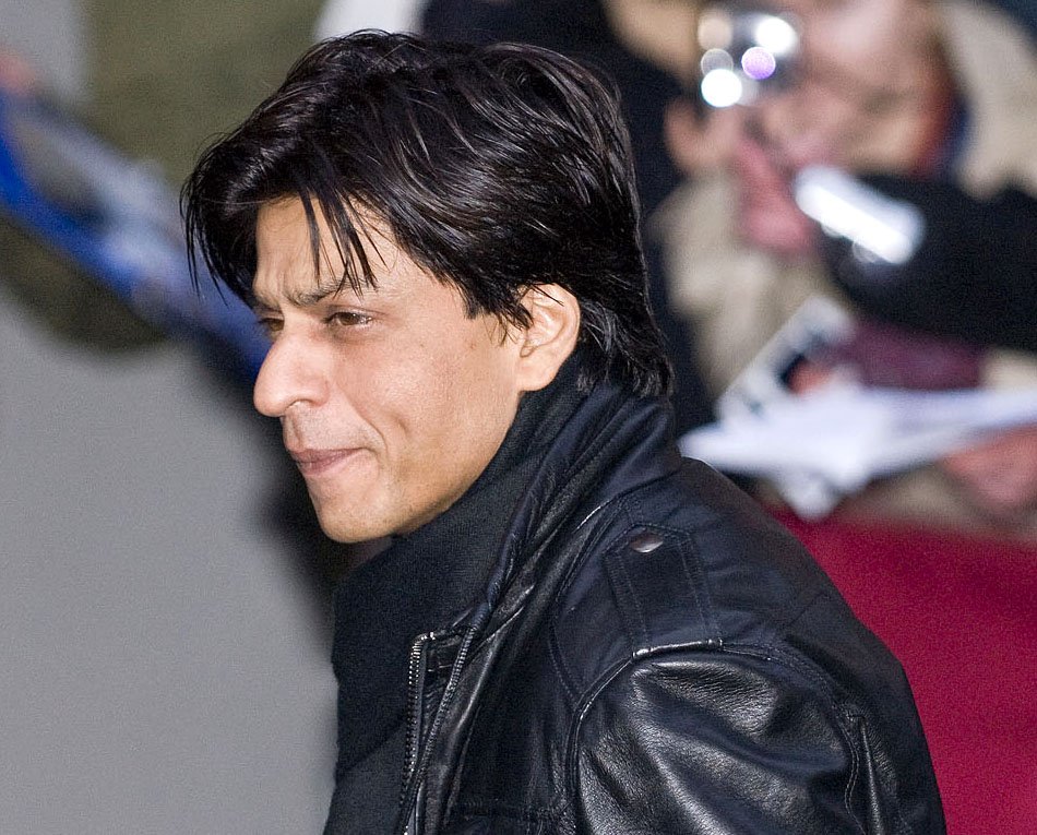Shah Rukh Khan wearing a black leather jacket with a raised collar