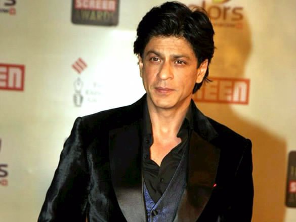 Shah Rukh Khan wearing a dark textured blazer over a waistcoat and black shirt