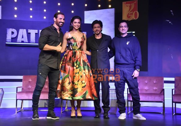 Shah Rukh Khan, second from right, wearing a dark jacket and T-shirt in a group event photograph